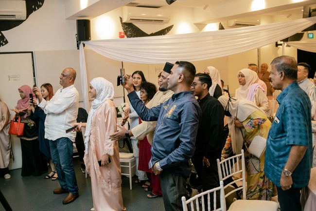 people gathering capturing the moment of the bride and groom